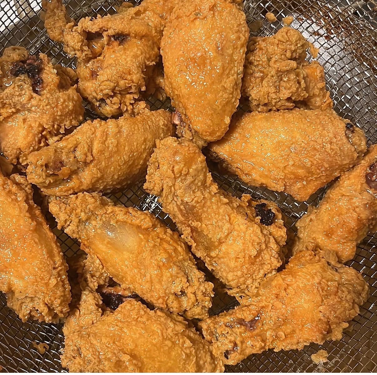 Golden fried chicken wings, fresh from the fryer